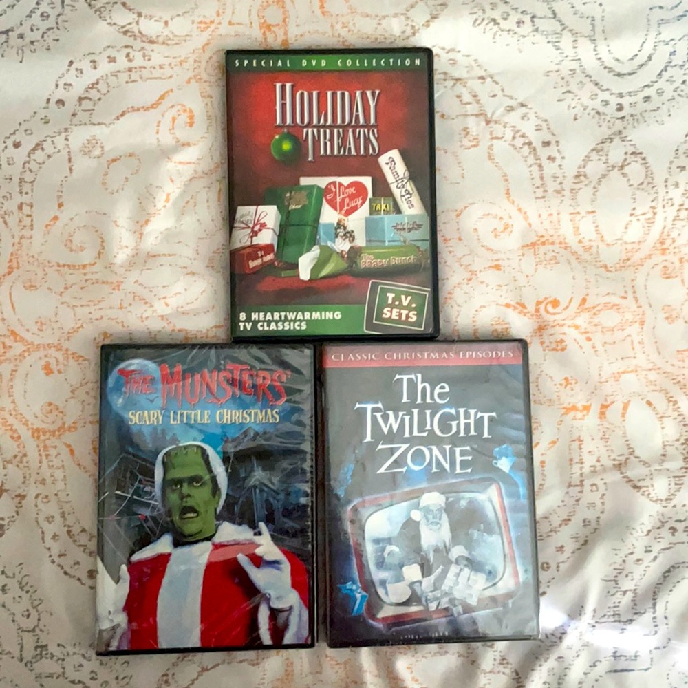 Three DVDs of holiday movies.